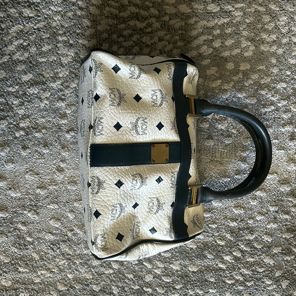 MCM  cream and navy barrel bag.  See pictures for worn areas